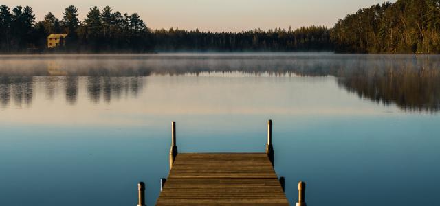 a dock on a lake by Rosemary Williams courtesy of Unsplash.